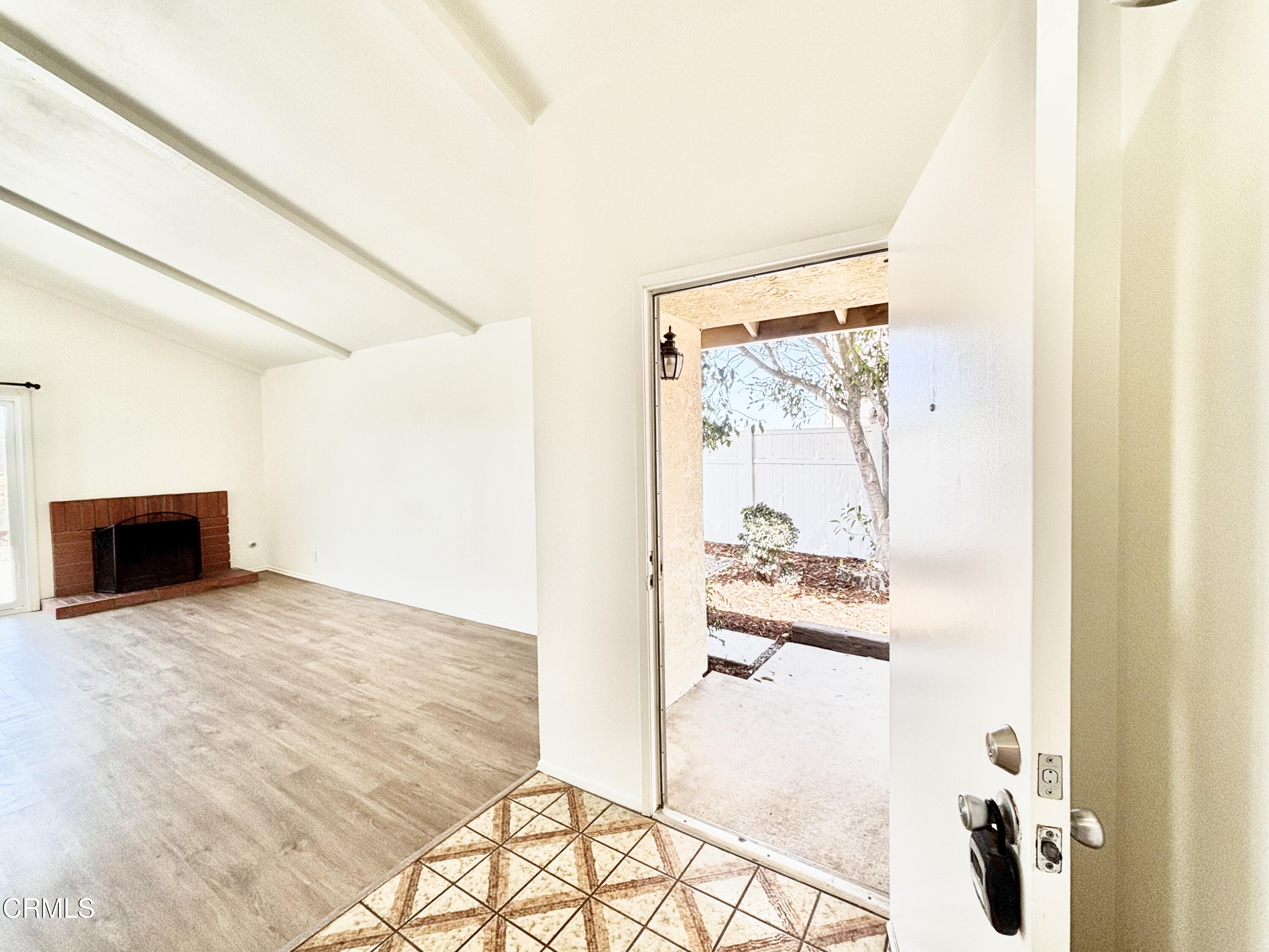4911 Catamaran Street Oxnard, CA 93035 - Photo 31 of 38 a view of a living room with a fireplace and workspace