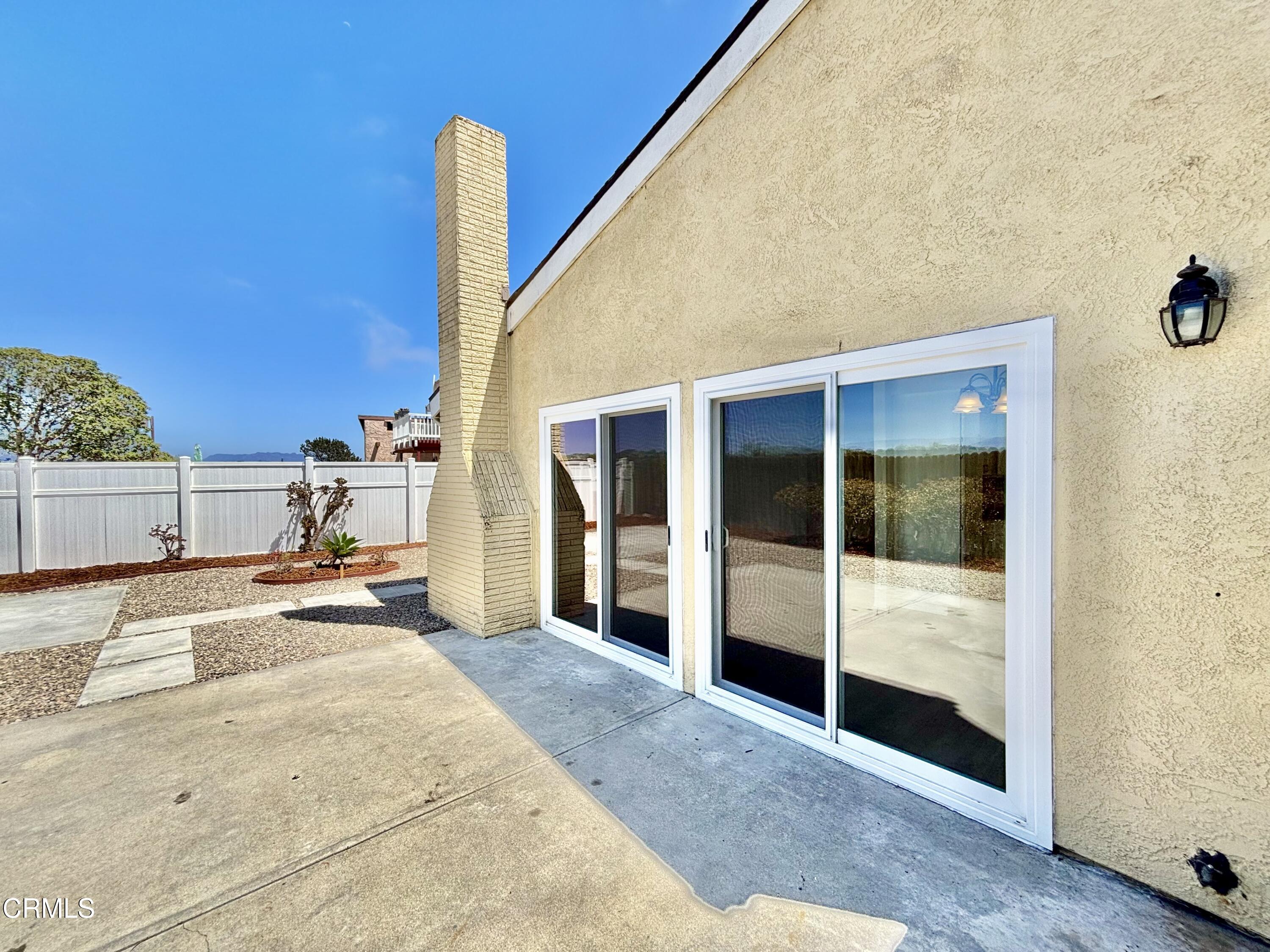 4911 Catamaran Street Oxnard, CA 93035 - Photo 33 of 38 a spacious bedroom with a large window and chandelier