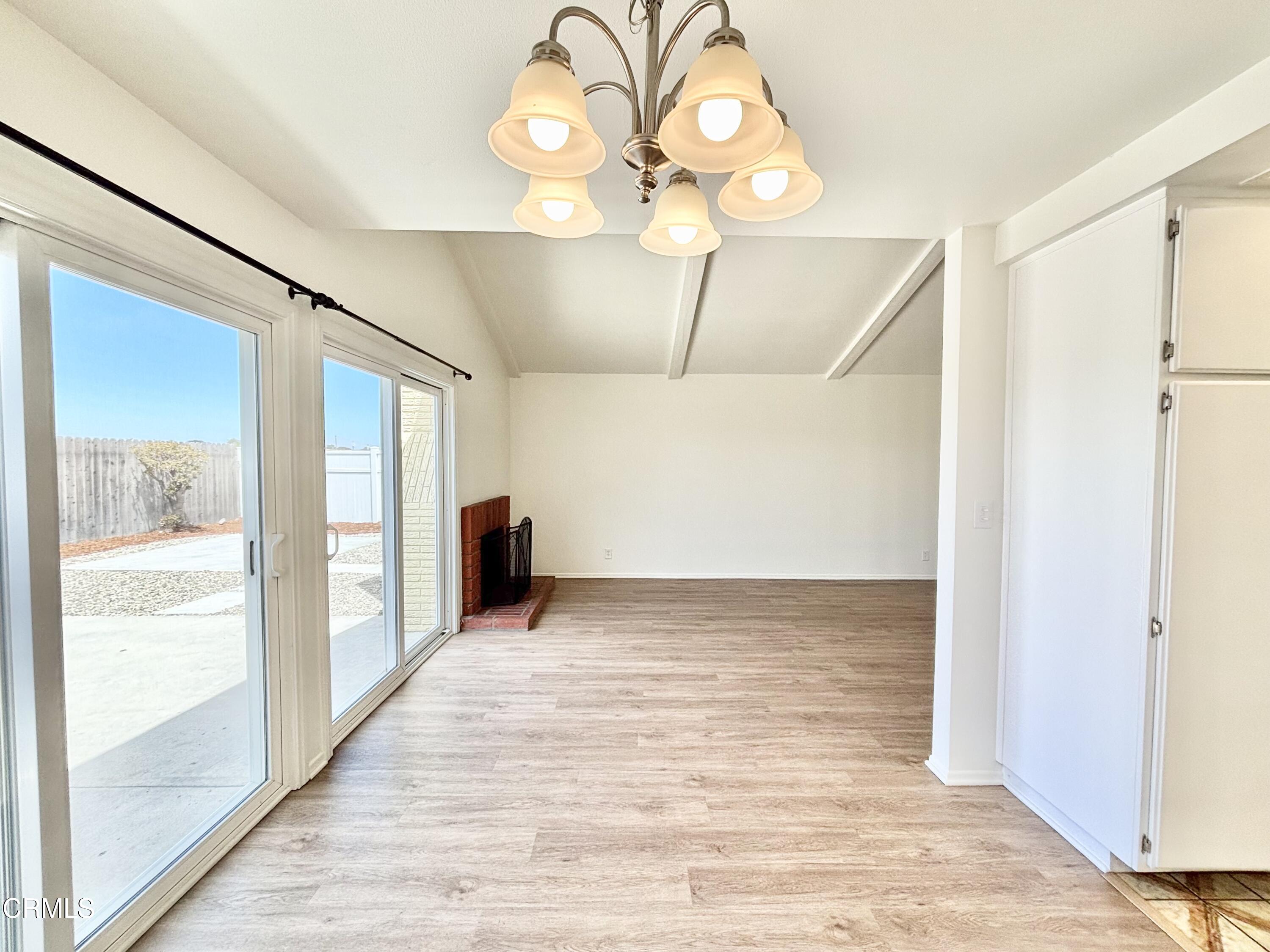 4911 Catamaran Street Oxnard, CA 93035 - Photo 4 of 38 a view of a hallway with wooden floor and a bathroom