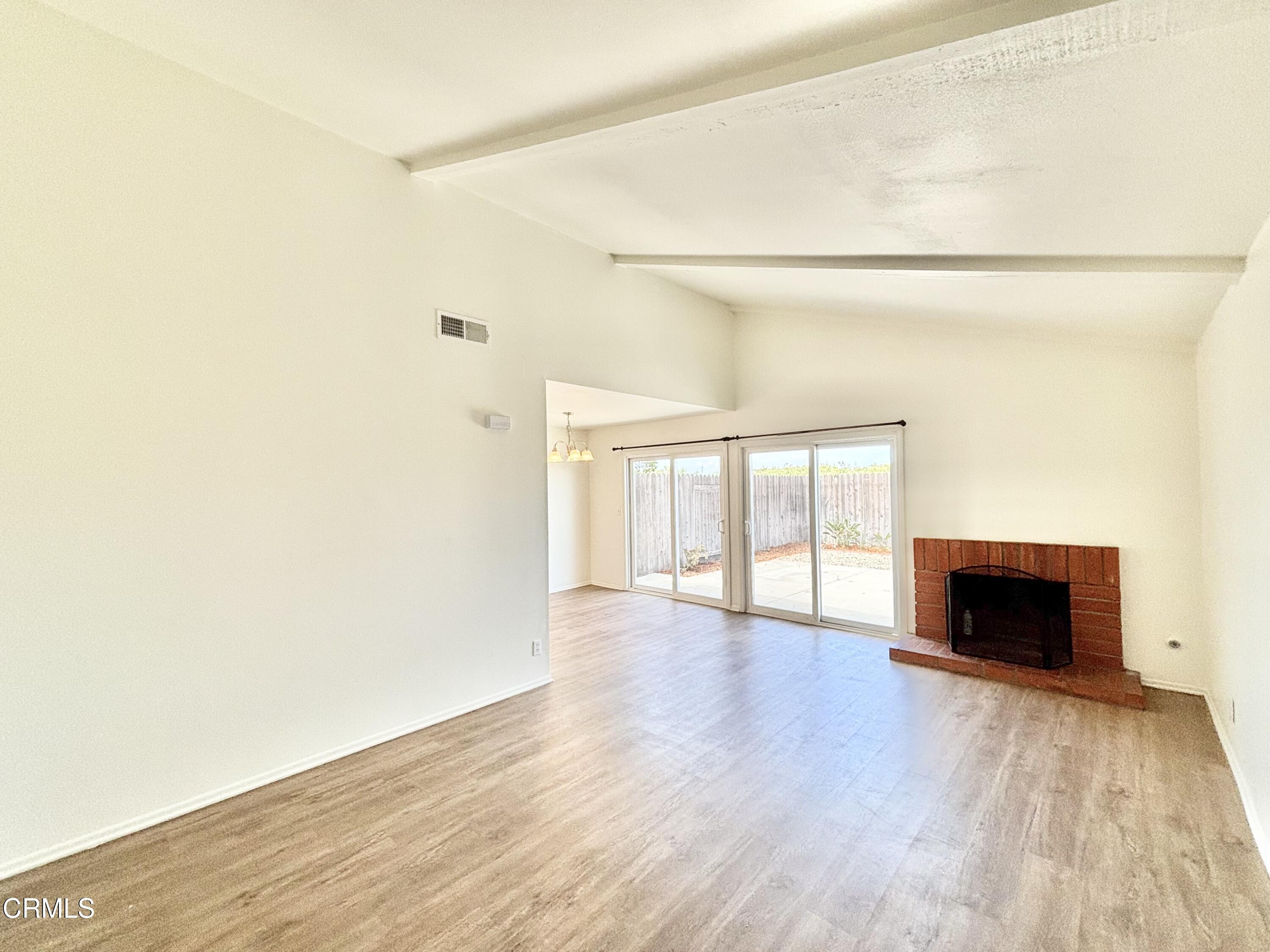 4911 Catamaran Street Oxnard, CA 93035 - Photo 5 of 38 a view of an empty room with wooden floor and a window