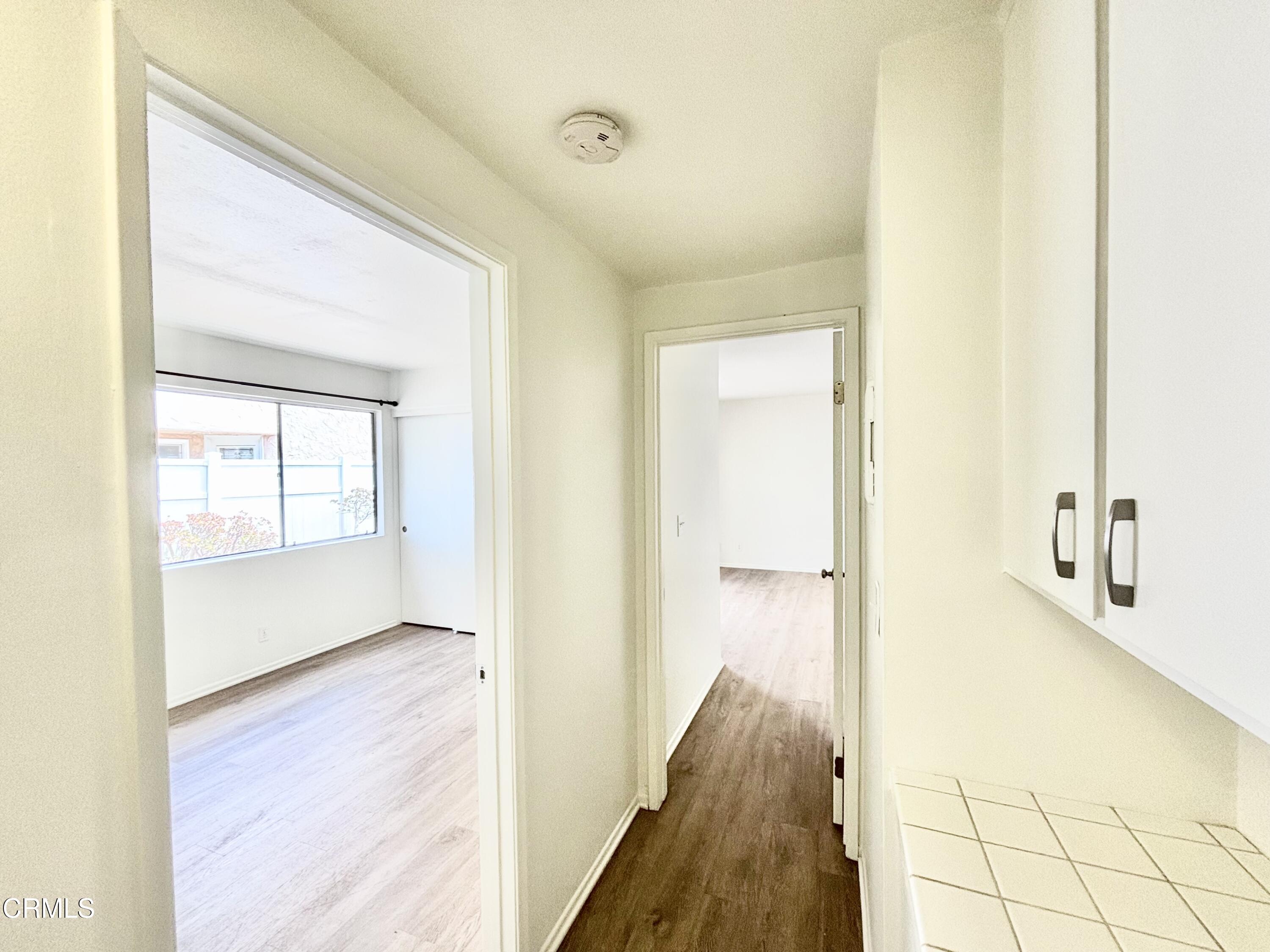 4911 Catamaran Street Oxnard, CA 93035 - Photo 9 of 38 a view of a hallway with wooden floor and staircase