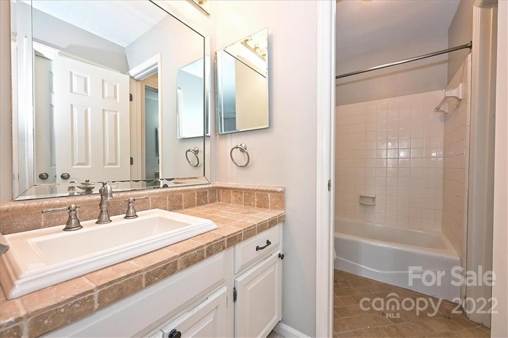 222 Queens Road, Unit 56 Charlotte, NC 28204 - Photo 15 of 23 a bathroom with a sink and a mirror