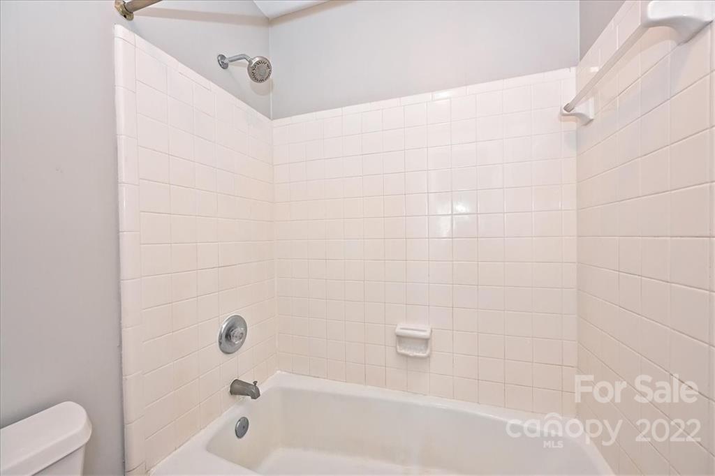 222 Queens Road, Unit 56 Charlotte, NC 28204 - Photo 16 of 23 a bathroom with a bathtub and a toilet