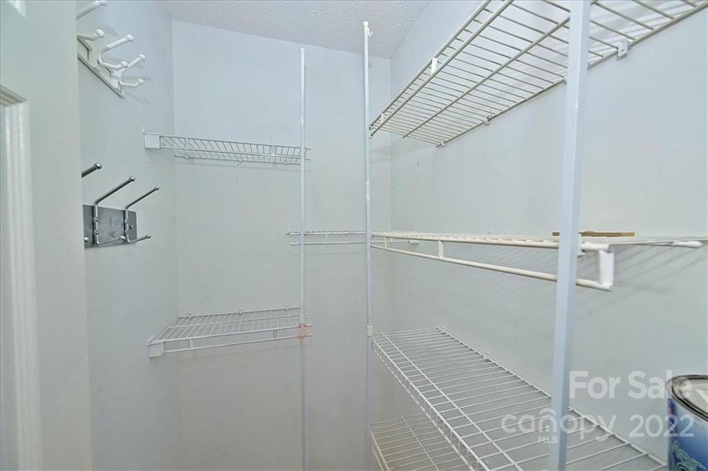 222 Queens Road, Unit 56 Charlotte, NC 28204 - Photo 18 of 23 a view of a room with racks on the wall