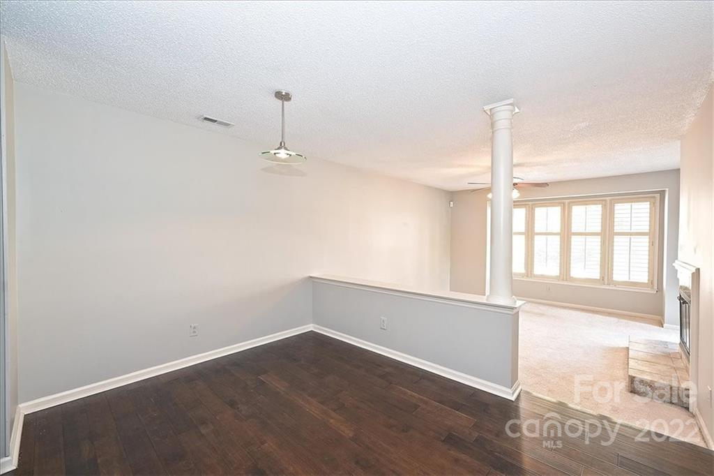 222 Queens Road, Unit 56 Charlotte, NC 28204 - Photo 5 of 23 an empty room with wooden floor and windows