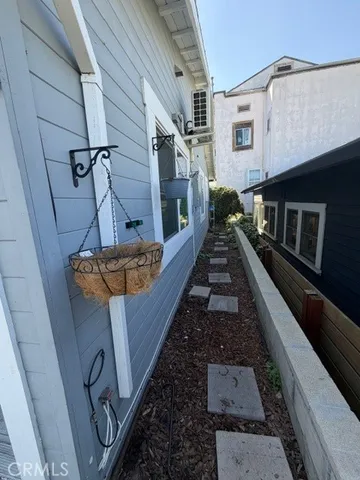 a kitchen with a sink a stove top oven and white cabinets