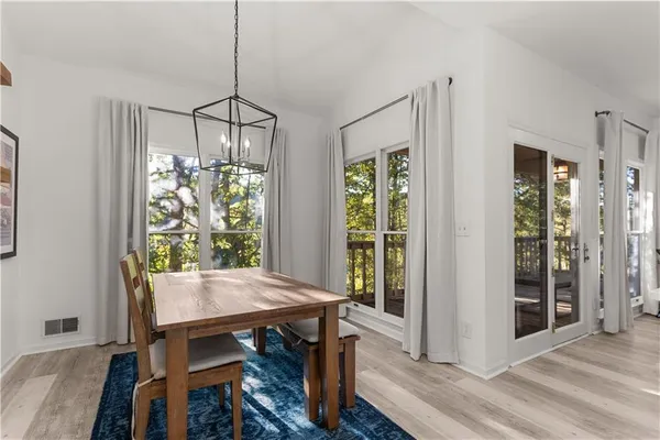 a view of a dining room with furniture window and wooden floor