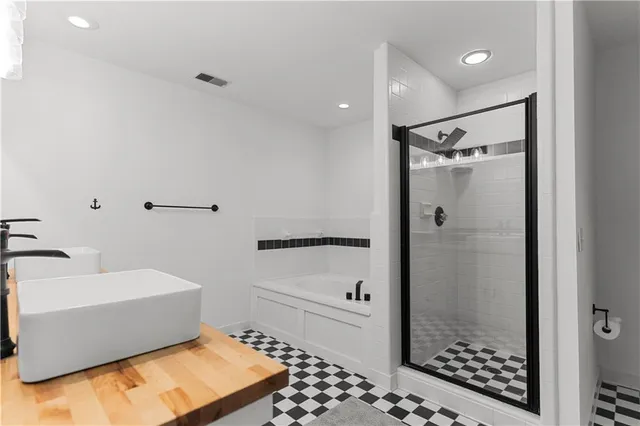 a bathroom with a bathtub and a shower