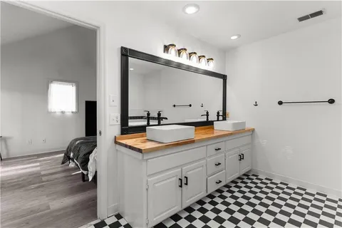 a spacious bathroom with a double vanity sink and mirror