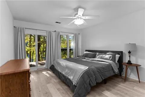 a bedroom with a large bed and a chandelier