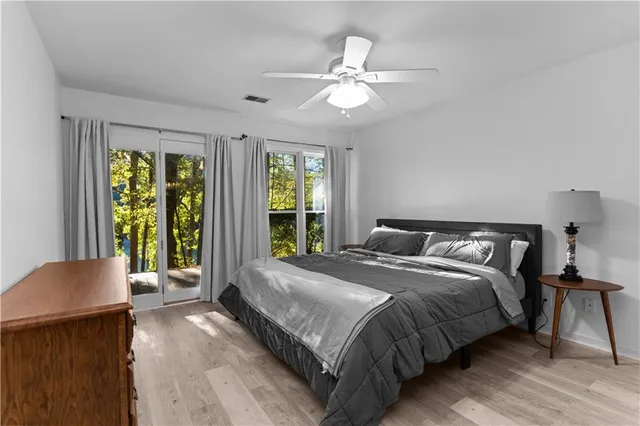 a bedroom with a large bed and a chandelier