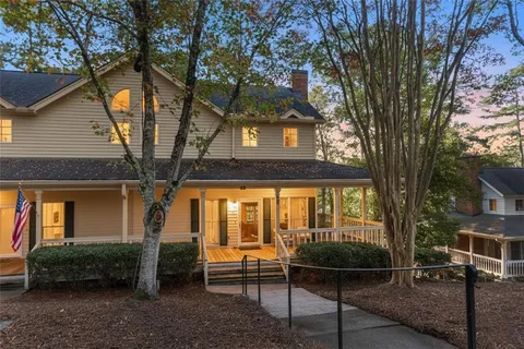 a view of a house with backyard and a tree