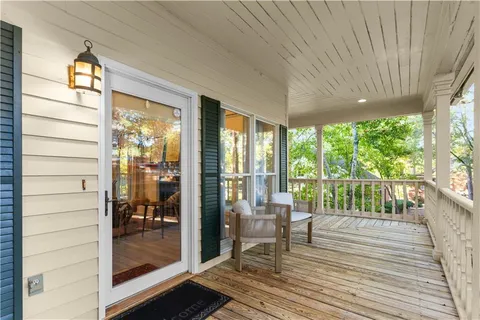 a balcony with chairs and wooden floor