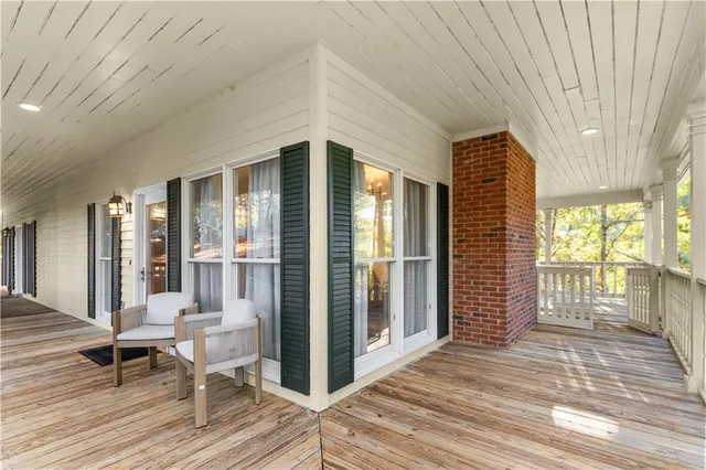 a view of a livingroom with wooden floor and furniture