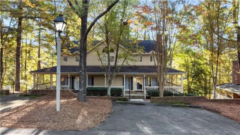 a front view of a house with a tree s
