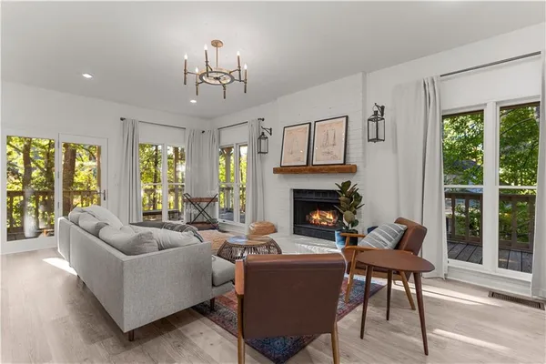 a living room with furniture fireplace and a large window