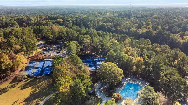 a view of swimming pool with outdoor seating and a garden
