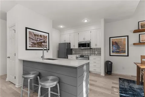a view of kitchen with cabinets and wooden floor