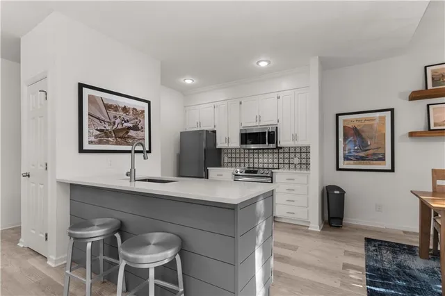 a view of kitchen with cabinets and wooden floor