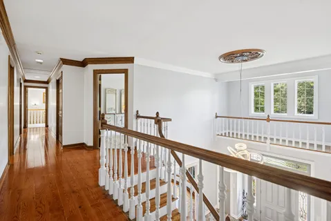 a view of a hallway with windows and stairs