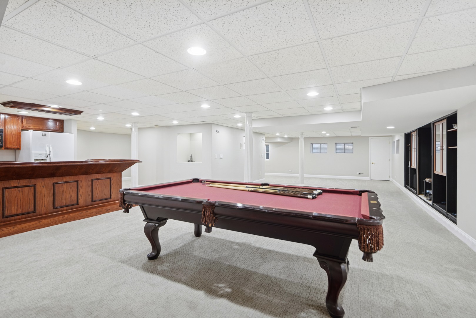 8120 Woodside Lane Burr Ridge, IL 60527 - Photo 18 of 24 a room with pool table windows a flat screen tv and kitchen view