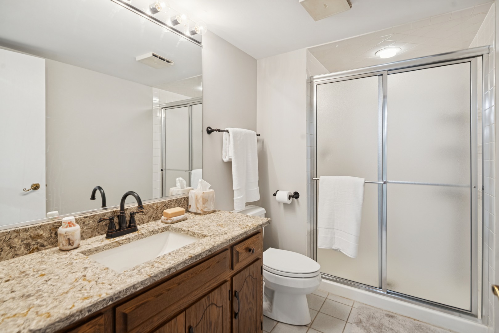 8120 Woodside Lane Burr Ridge, IL 60527 - Photo 19 of 24 a bathroom with a granite countertop sink toilet and shower