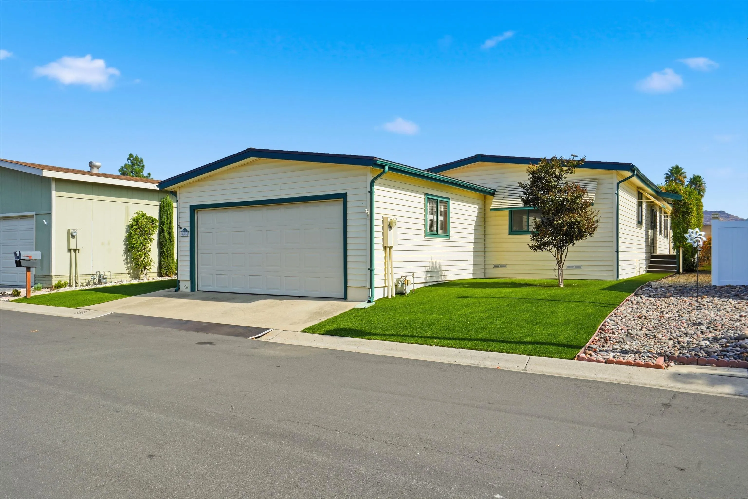 9255 North Magnolia Avenue, Unit 339 Santee, CA 92071 - Photo 3 of 55 a front view of a house with a yard and garage