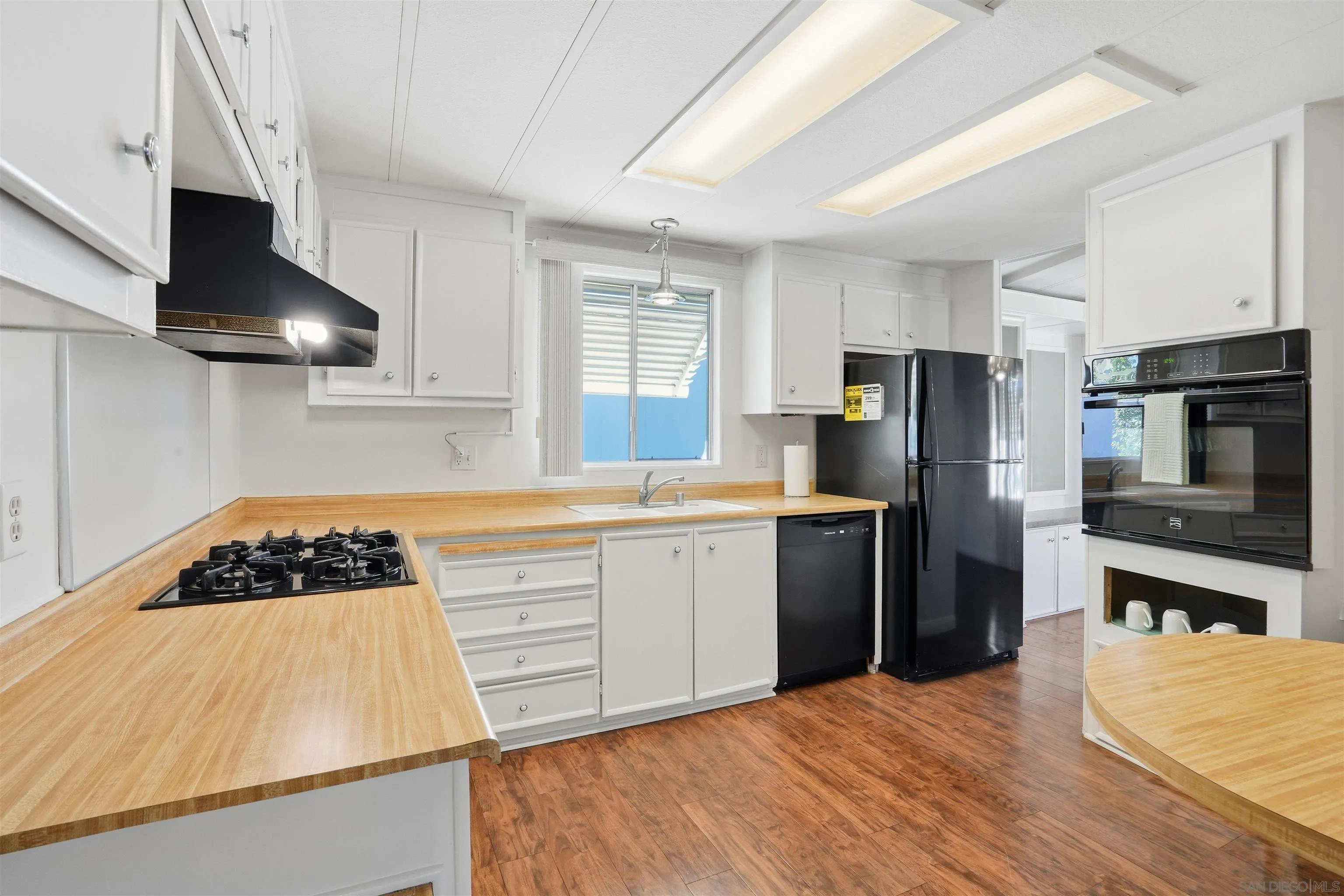 9255 North Magnolia Avenue, Unit 339 Santee, CA 92071 - Photo 6 of 55 a kitchen with a refrigerator and a stove