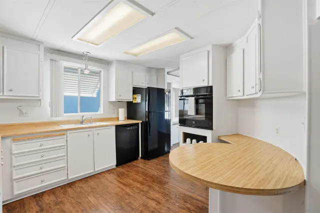 a kitchen with stainless steel appliances granite countertop a sink dishwasher stove and refrigerator