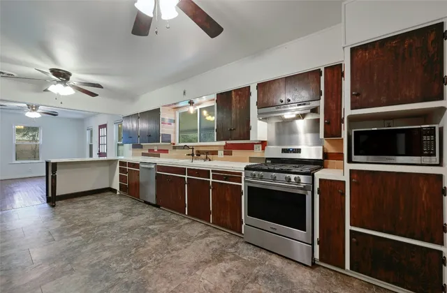 a kitchen with stainless steel appliances granite countertop a stove and a sink
