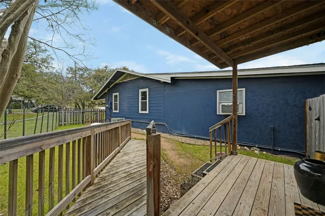 a view of balcony with wooden floor and iron fence