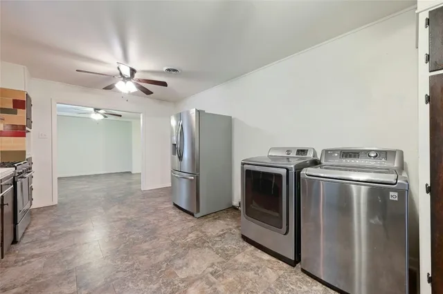 a view of a kitchen with a stove fridge and wooden floor