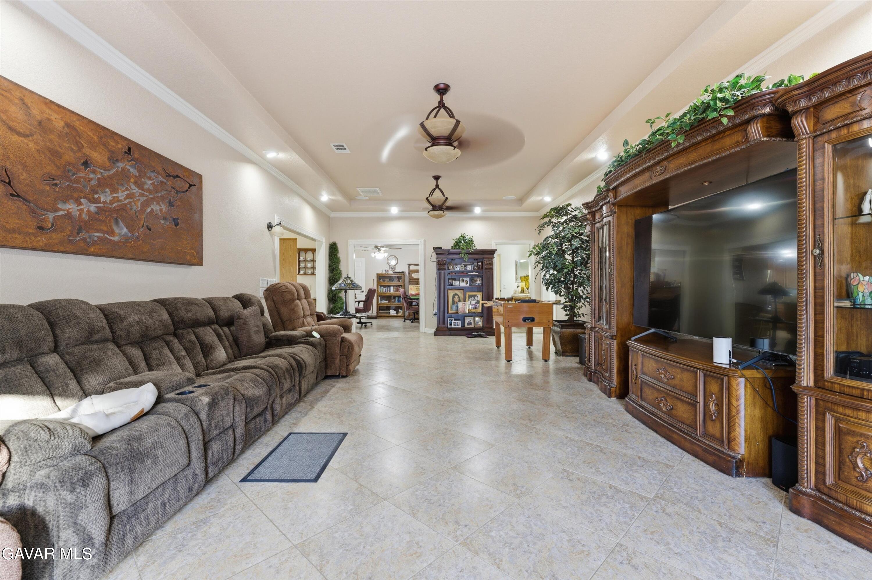 5801 Hacienda Ranch Road Palmdale, CA 93551 - Photo 24 of 69 a living room with furniture and a flat screen tv