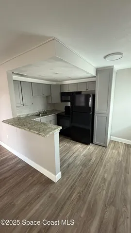 a view of kitchen stove refrigerator and microwave