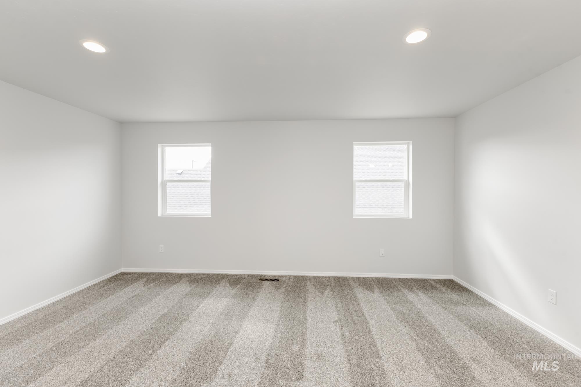 10833 Rutland Street Caldwell, ID 83605 - Photo 12 of 26 Empty room featuring carpet and recessed lighting