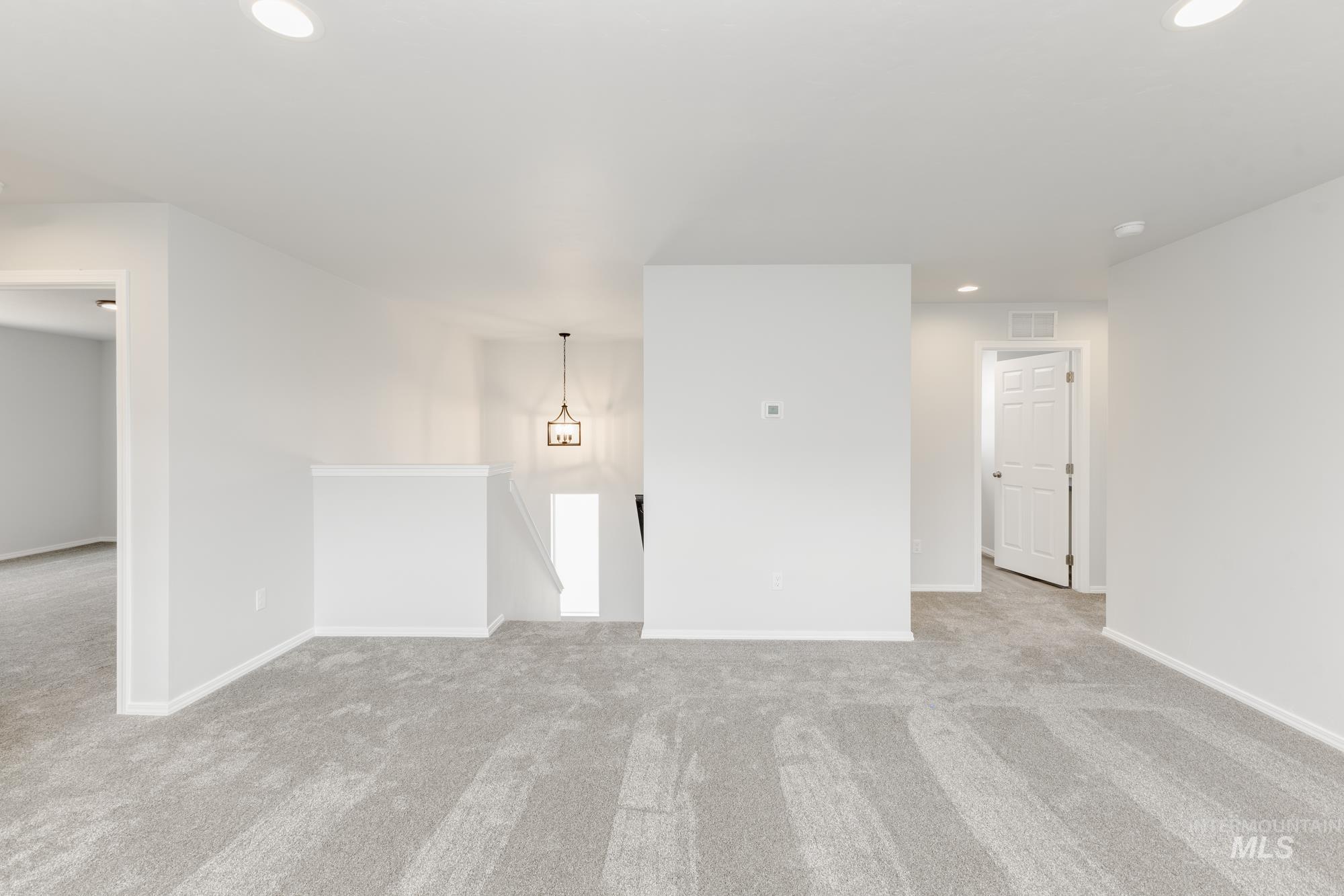10833 Rutland Street Caldwell, ID 83605 - Photo 14 of 26 Unfurnished room with light colored carpet and recessed lighting