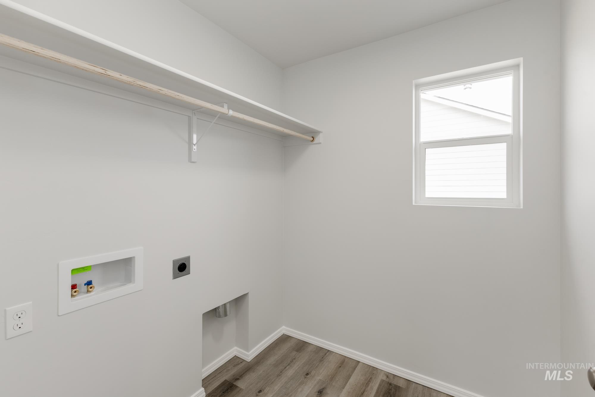 10833 Rutland Street Caldwell, ID 83605 - Photo 17 of 26 Laundry room featuring light wood-style flooring, hookup for an electric dryer, and hookup for a washing machine