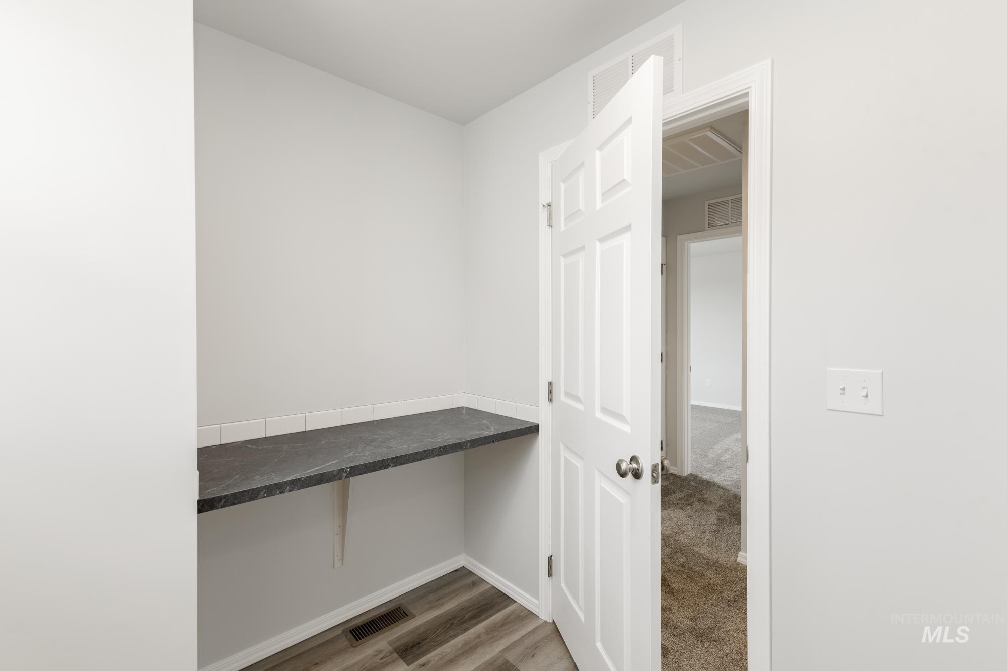 10833 Rutland Street Caldwell, ID 83605 - Photo 18 of 26 Mudroom with baseboards and dark wood finished floors