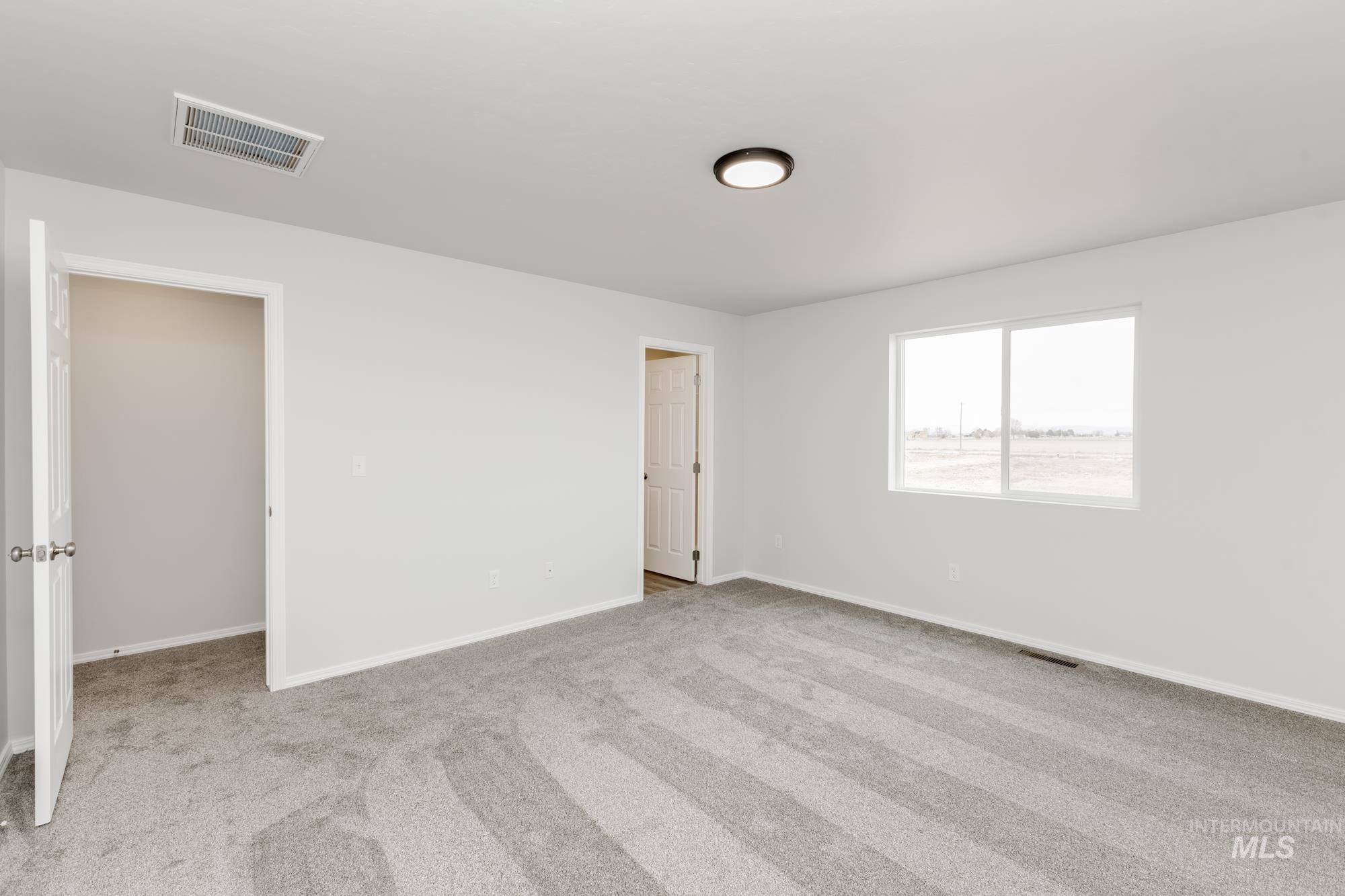 10833 Rutland Street Caldwell, ID 83605 - Photo 22 of 26 Spare room with light colored carpet and baseboards