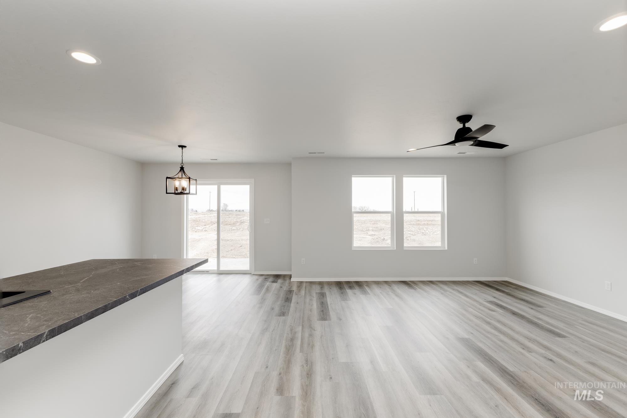 10833 Rutland Street Caldwell, ID 83605 - Photo 7 of 26 Unfurnished living room featuring recessed lighting, healthy amount of natural light, light wood-style flooring, and a ceiling fan
