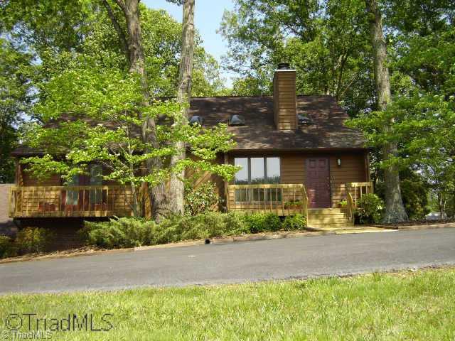 8000 Eastridge Road Oak Ridge, NC 27310 - Photo 1 of 8 Exterior Front. Beautiful home ready for new owners on 5.41 acres. New front & back decks. New kitchen and TONS of space inside and out!!!