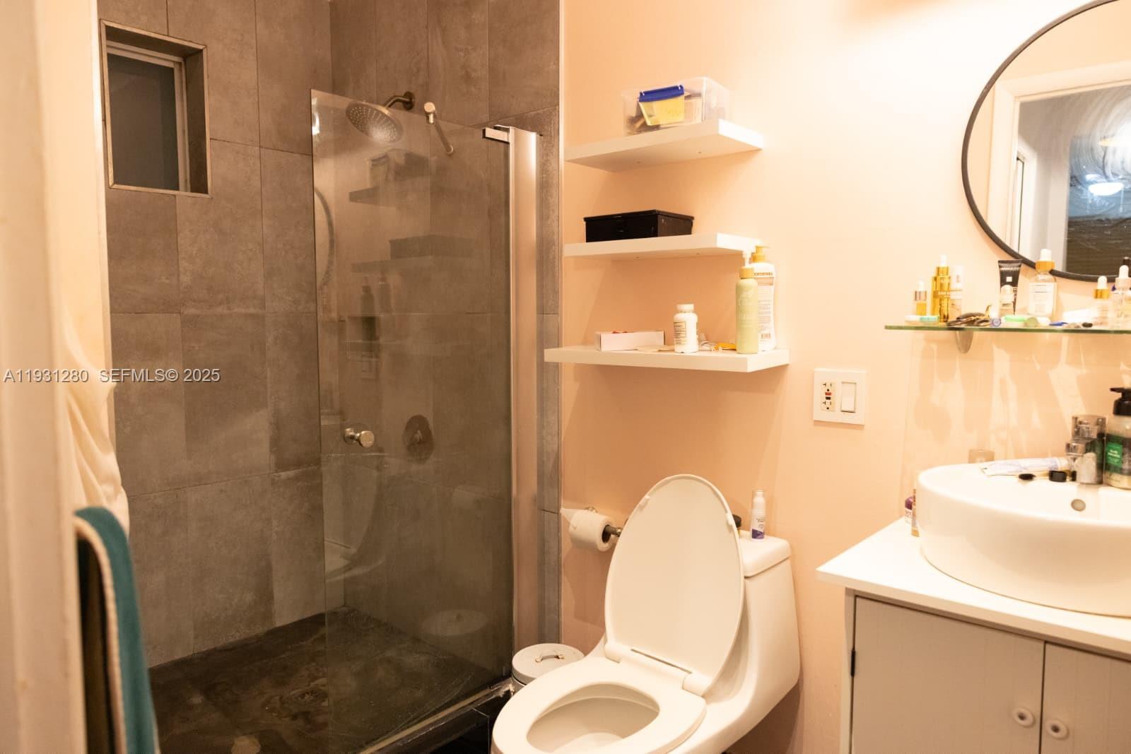 6260 Southwest 24th Street, Unit B Miami, FL 33155 - Photo 12 of 13 a bathroom with a sink toilet and shower