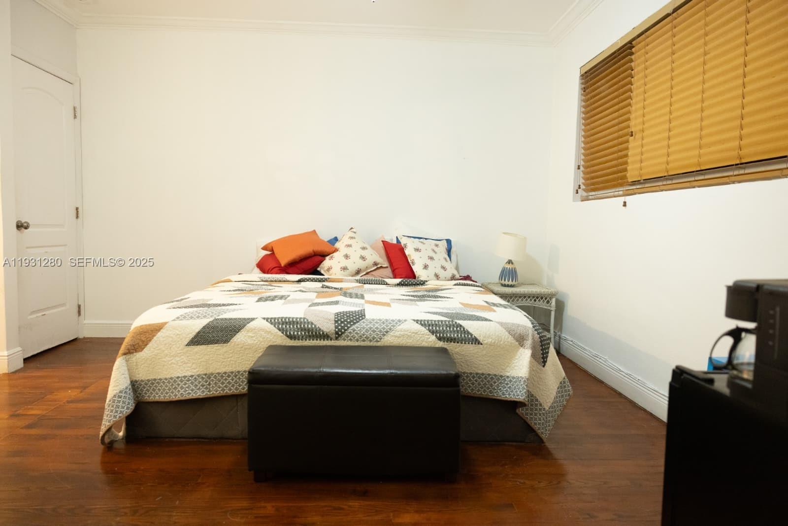 6260 Southwest 24th Street, Unit B Miami, FL 33155 - Photo 4 of 13 a bedroom with a bed and wooden floor