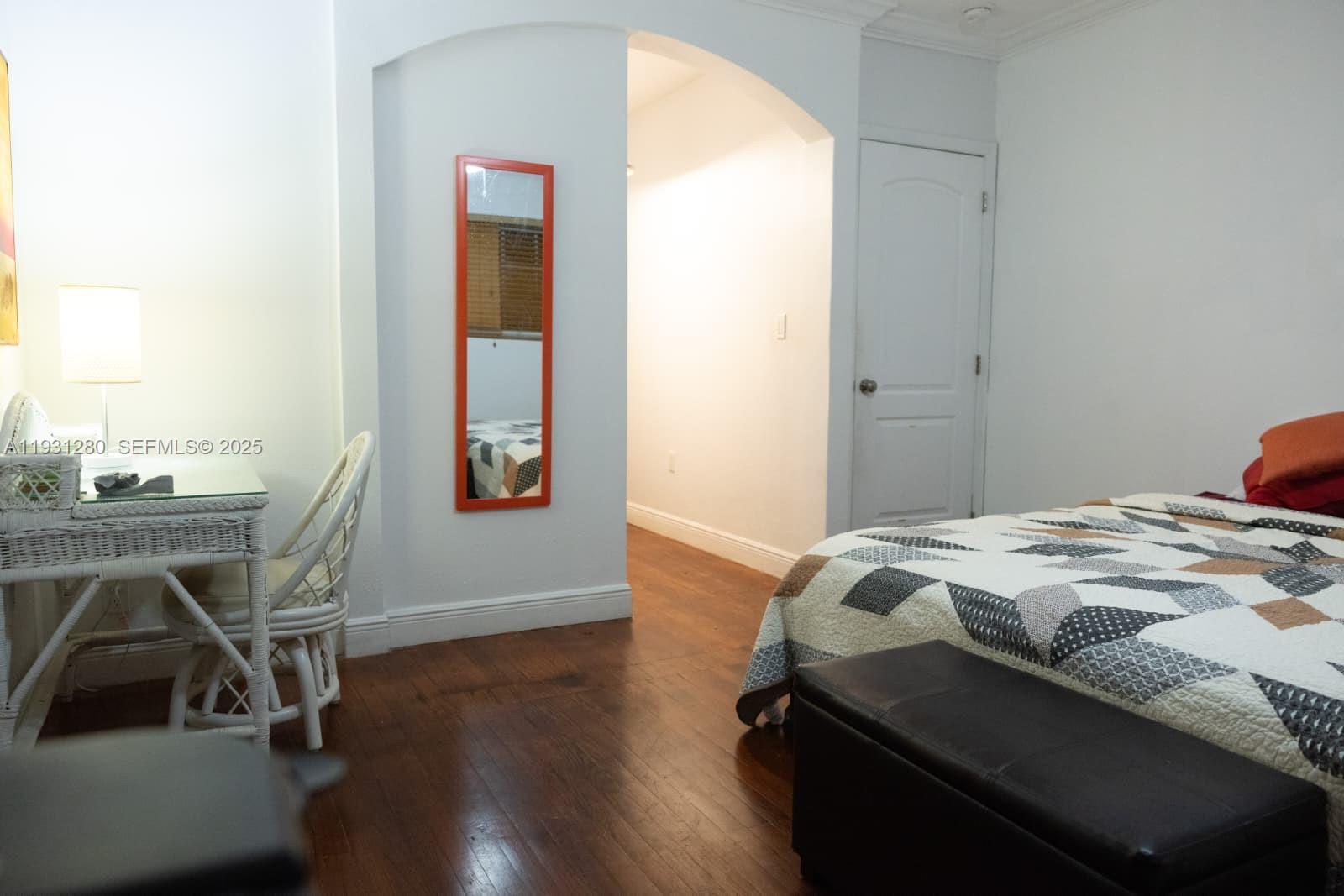 6260 Southwest 24th Street, Unit B Miami, FL 33155 - Photo 5 of 13 a bedroom with a bed and a table in it