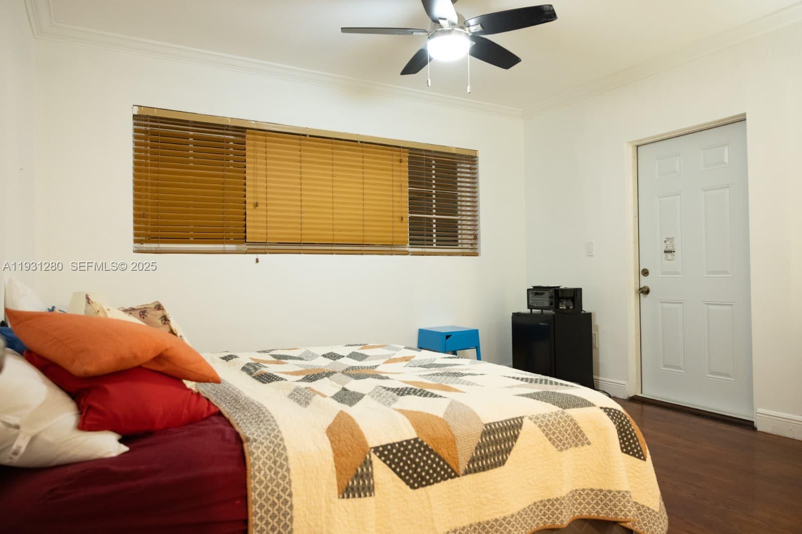 6260 Southwest 24th Street, Unit B Miami, FL 33155 - Photo 7 of 13 a bedroom with a bed and a chandelier