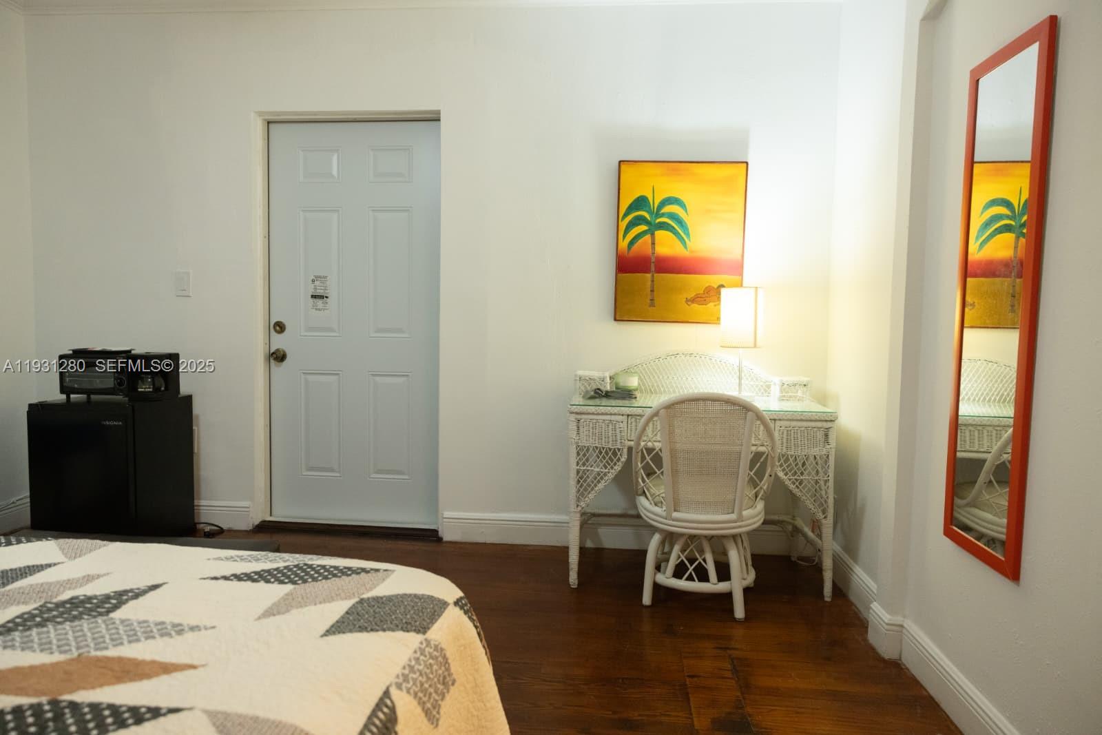6260 Southwest 24th Street, Unit B Miami, FL 33155 - Photo 8 of 13 a bedroom with a bed and a chair