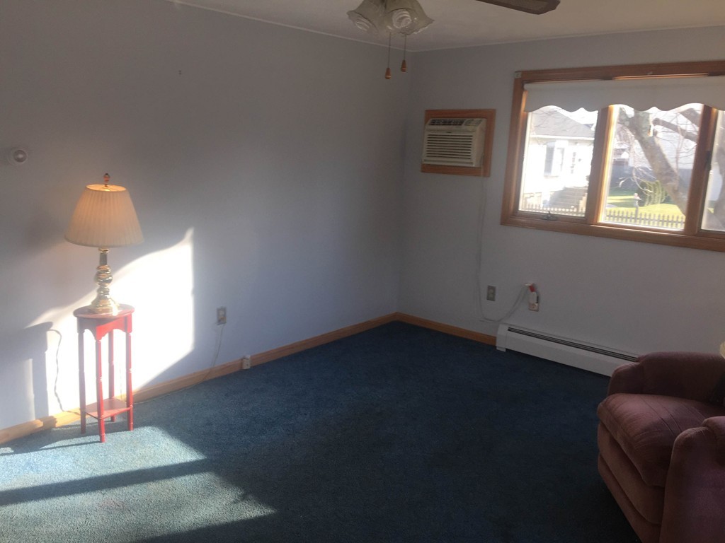 254 Jackson Street Fall River, MA 02721 - Photo 6 of 15 a view of an empty room with wooden floor and a window