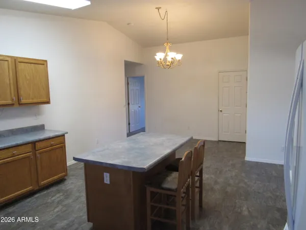 a view of a dining room with a table and chairs