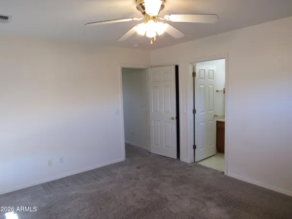 an empty room with a fan and a fan