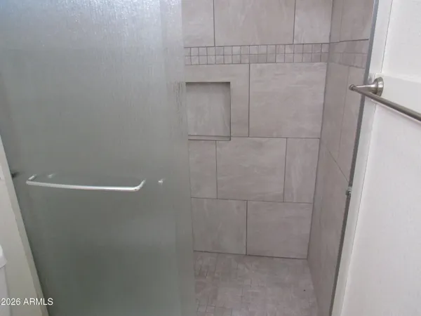 a bathroom with a glass shower door